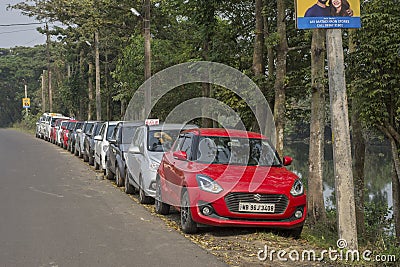 12th December, 2021, Narendrapur, West Bengal, India: Few mordern cars parked road side for sale second hand Editorial Stock Photo