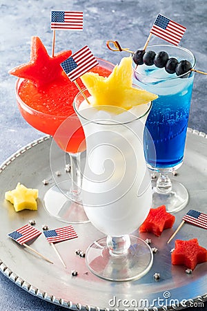 4th of July cocktails garnished with patriotic flags and fruit stars. Stock Photo