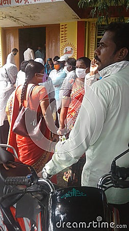 Group of people, male and female waiting outside of Indian hospital Editorial Stock Photo