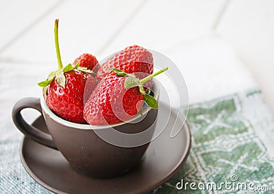 Th strawberries in the cup on the towel Stock Photo