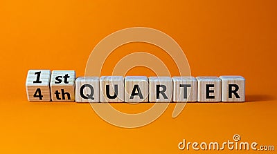 From 4th to 1st quater symbol. Turned wooden cubes and changed words `4th quater` to `1st quater`. Beautiful orange table, ora Stock Photo