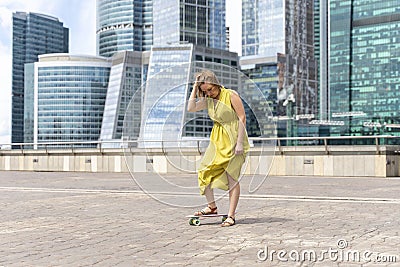 30th woman is learning to skateboard Stock Photo