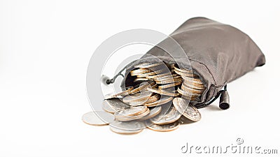 Thai baht coins in black bag overflow with copyspace Stock Photo