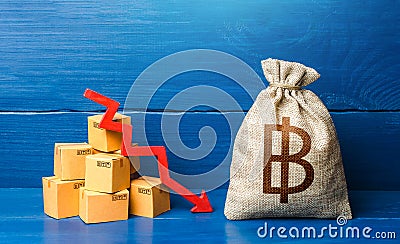 Thai baht money bag with boxes and down arrow. Low sales. Income decrease, slowdown and decline of economy. Bad consumer sentiment Stock Photo