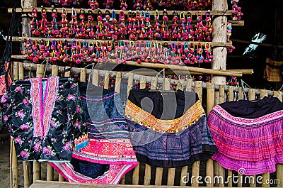 Thai Bamboo bench with colorful hand-woven dress fabrics Stock Photo