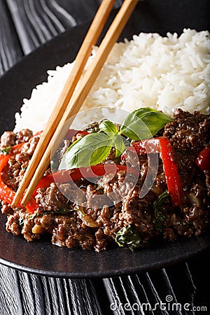 Thai Basil Beef, or Pad Gra Prow with rice side dish close-up. vertical Stock Photo