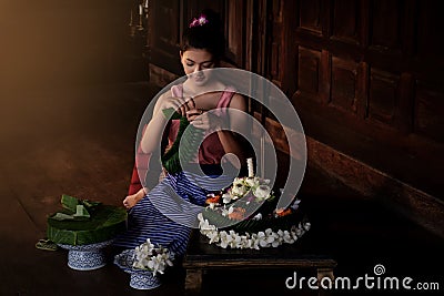 Thai beautiful women wearing traditional dresses make Krathong f Stock Photo