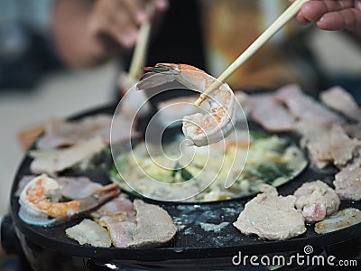 Thai buffet with pork, shrimp and other meats grilled fried cooked on brass barbecue pan food cha-bu Stock Photo