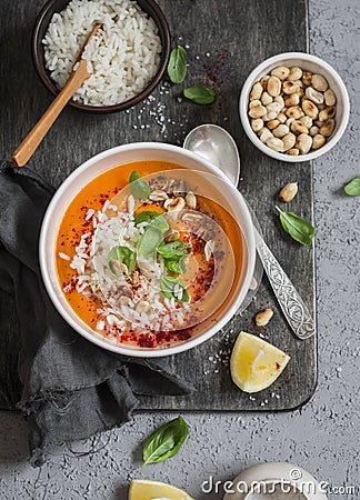 Thai carrot sweet potato soup with rice on the dark table, top view. Stock Photo