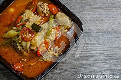 Thai chicken spicy tom yum soup with wooden background Stock Photo