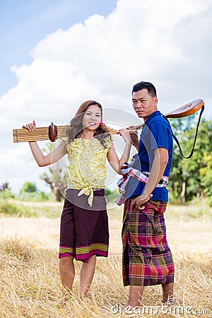 Thai costume and ancient musical instrument Stock Photo