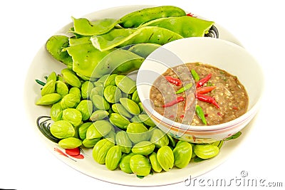 Thai cuisine Bitter Beans and Spicy Chili Paste Nam Prik serve with vegetables isolated on white background Stock Photo
