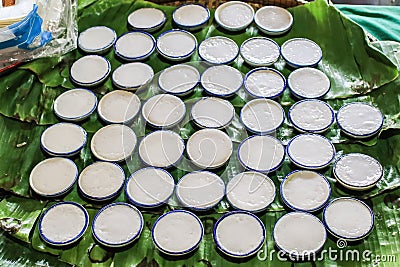 Thai dessert-coconut milk custard or Khanom Thuai in small porcelain cup.Steamed pandan and coconut milk Cake .Made from rice flou Stock Photo