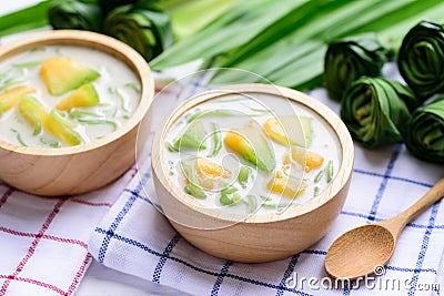 Thai dessert Lod Chong,rice flour pandan flavor and sliced melon fruit in coconut milk Stock Photo