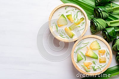 Thai dessert Lod Chong,rice flour pandan flavor and sliced melon fruit in coconut milk Stock Photo