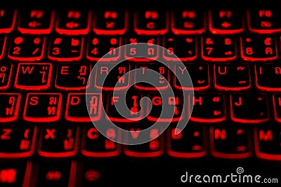 Thai - English language laptop keyboard with glowing red light Stock Photo