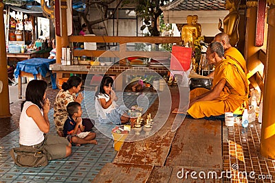 Thai Family pay respects to buddhist monks Editorial Stock Photo