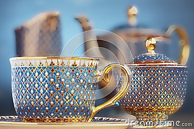 Thai fine art traditional five colors (Bencharong) tea cup over blue blurry background. Stock Photo