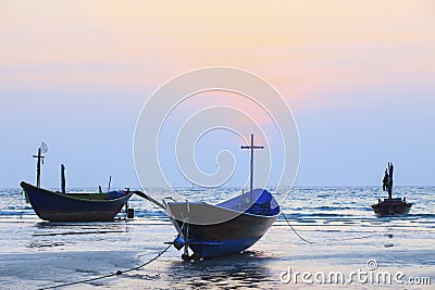 Thai fishery boat on sea beach against beautiful dusky sky use f Stock Photo