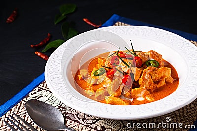 Thai Food concept Authentic Thai chicken Panang Curry, Panang Kai in ceramic bowl on black background with copy space Stock Photo