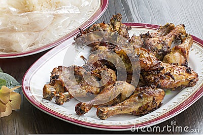 Thai food and traditional menu.Roast chicken and sticky rice with dish on wood. Stock Photo