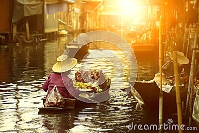 Thai fruit seller sailing wooden boat in thailand tradition floating market Stock Photo