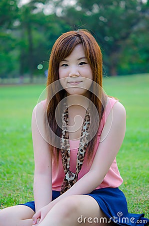 Thai girl relaxing in the park Stock Photo