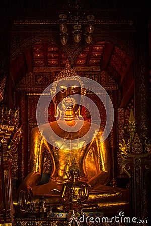 Thai golden buddha vertical dark gold peace calm Stock Photo