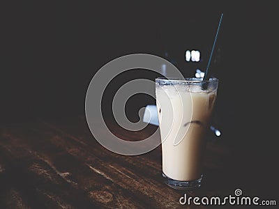 This is Thai iced tea in the glass above wooden desk, soft tone Stock Photo