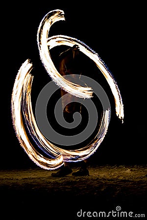 Thai man fire juggling at night on a beach of Koh Lipe island in Thailand Stock Photo