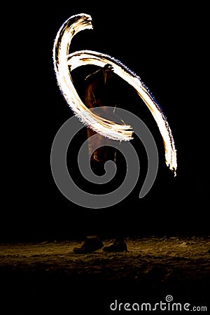 Thai man fire juggling at night on a beach of Koh Lipe island in Thailand Stock Photo