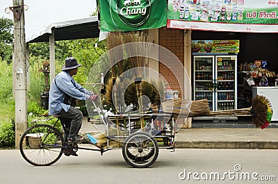 Thai man people riding tricycle cart for sale equipment and housekeeping tool on the road Editorial Stock Photo