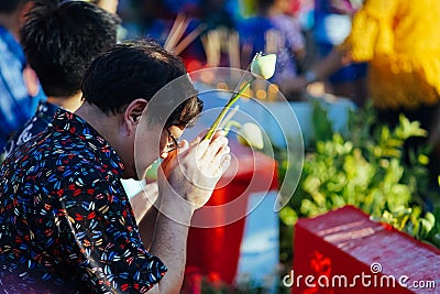 A Thai man prays during Songkhran celebration Editorial Stock Photo