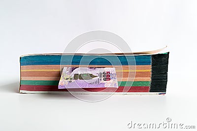The Thai money inthe thick book on white background. Stock Photo