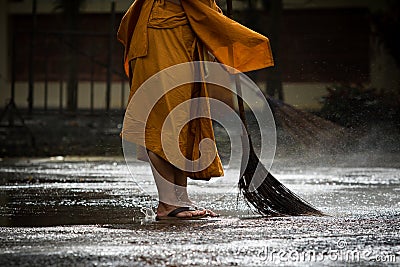 Thai monk daily cleaning in buddist temple Stock Photo