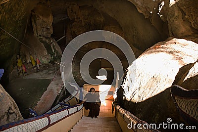 Thai monk people walking up on stairs go to visit Wat Tham Phra Khao Chaison Caves Editorial Stock Photo