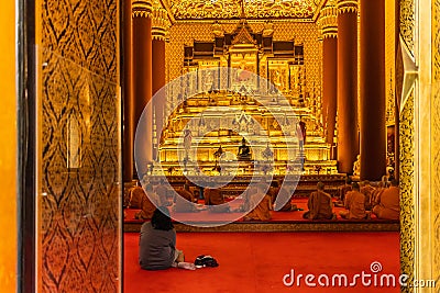 Thai monk pray for buddha at beautiful temple of Bangkok Thailand in back view Editorial Stock Photo