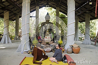 Thai old woman pray flower and burning incense at thurible for r Editorial Stock Photo