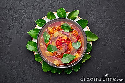 Thai Panang Chicken Curry in black bowl at dark slate background. Phanaeng Curry is Thai Cuisine dish Stock Photo