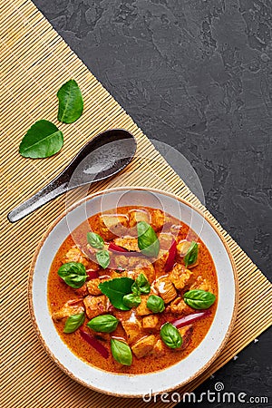 Thai Panang Chicken Curry in white plate at black slate background. Phanaeng Curry is thai cuisine dish. Thai food Stock Photo