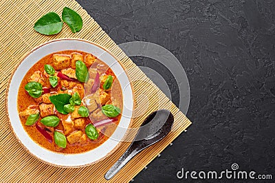 Thai Panang Chicken Curry in white plate at black slate background. Phanaeng Curry is thai cuisine dish. Thai food Stock Photo