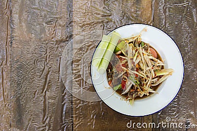 Thai papaya sald Somtum on wood background Stock Photo