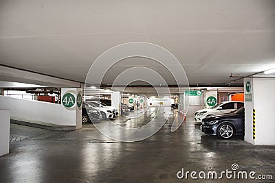 Thai people and foreign travelers drive vehicle to stop in car parking underground building for travel relax and shopping at Editorial Stock Photo