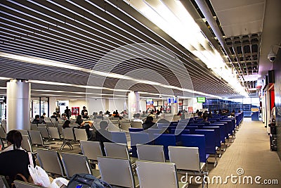 Thai people and foreigner travelers walking and sitting waiting check in inside of Udonthani International Airport in Thailand Editorial Stock Photo