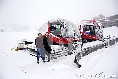 Thai people husband and wife travel and posing for take photo with Snowploughs machine Editorial Stock Photo