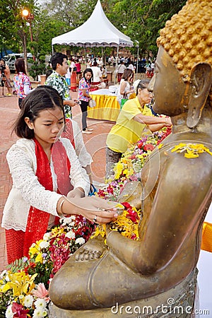 Thai people water pouring to Buddha statue in Editorial Stock Photo