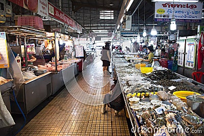 Thai people wearing fabric mask select buying products food and seafood from vendors grocery stall at fresh local seafood market Editorial Stock Photo