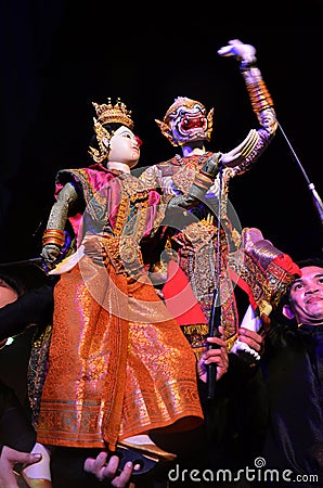 Thai professional puppeteer or Puppet master manipulate playing acting ancient puppets toy or antique marionette on stage for show Editorial Stock Photo