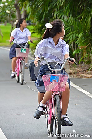 Thai Schoolgirl riding a bicycle Editorial Stock Photo