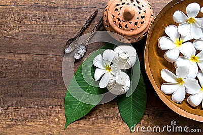 Thai spa composition treatments aroma therapy with candles and Plumeria flowers on wooden table Stock Photo